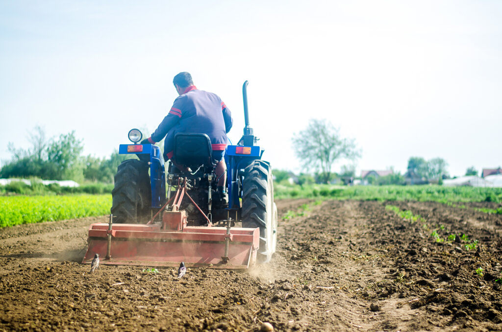 A farmer on a tractor works the soil of a farm field. Loosening surface, land cultivation. Farming, agriculture. Plowing field. Use of agricultural machinery and to simplify and speed up work. #Physiknobelpreis.
(c) AdobeStock